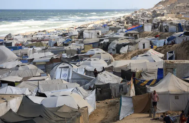 A crowded tent camp on the beach.