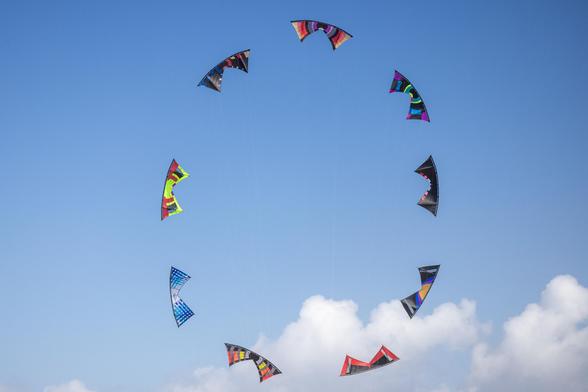 9 quad-lined kites forming a ball in the sky