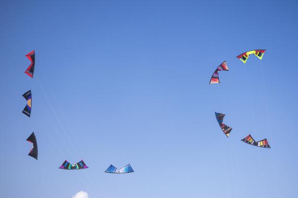 9 quad-lined kites spelling "LC" in the sky, standing for Lincoln City, OR where the festival was held