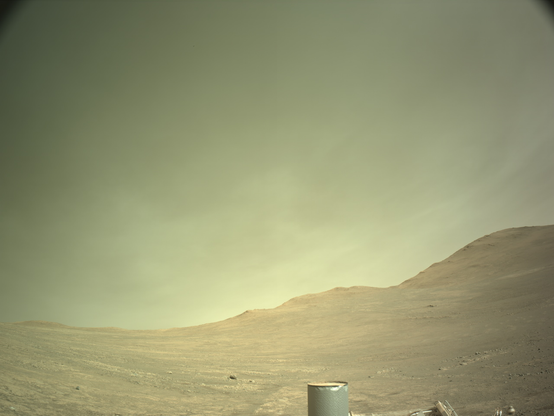 A Martian landscape with thin clouds lying low above the rim of Jezero Crater.