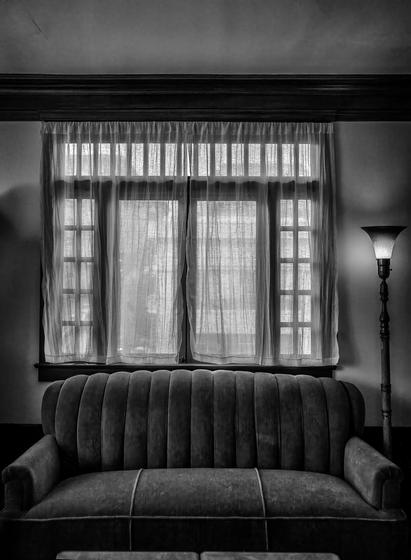 Window with couch below it from a flat in San Francisco furnished to look like it might in the late 1920s.