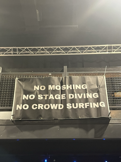 A sign the concert venue posed that says “No moshing, No stage diving, no crow surfing”