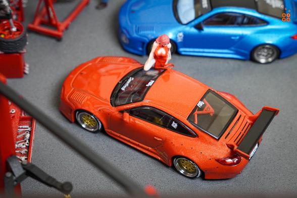 A top up view of Old & New 997 Red Metallic by Tarmac Works in 1:64 scale with 1:64 figure on AREA 164.