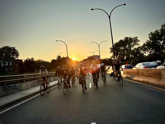 Group of cyclists using the 2 full lines with sunset backlight 