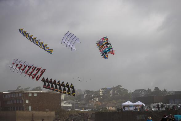 5 stacks of quad kites. Each stack is a series of individual kites that are tethered to the kite in front