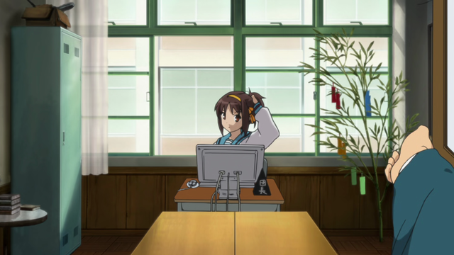 A girl (Haruhi) sitting behind a computer monitor with her hand putting her hair up in a pony tail. She's seen from across the room with a hand on screen having opened a door.