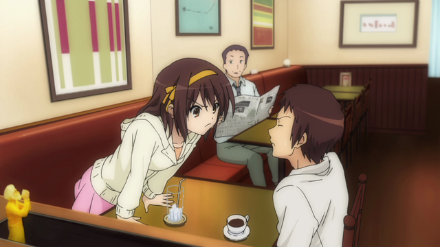 A girl (Haruhi) with a mad expression leaning in towards a boy (Kyon) across the table from her. They're sitting in a restaurant with a man behind them holding a newspaper appearing confused.