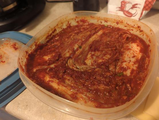 Tupperware crammed with freshly made kimchi. My friend Brent sees a frightened woman's face in it. It's almost gone now and I plan to make more and I enjoyed it the most when it was totally fresh, before any fermentation. Also, I'd never eaten kimchi before making this.