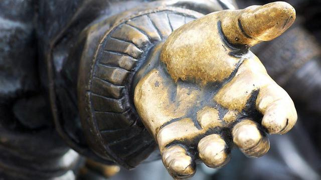 Hand of a statue reaching out.