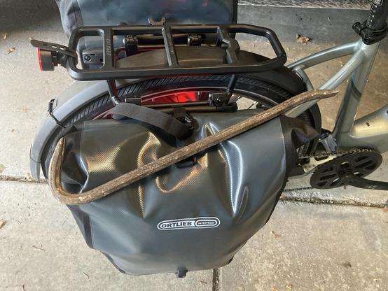 A pry bar resting on a bike pannier.
