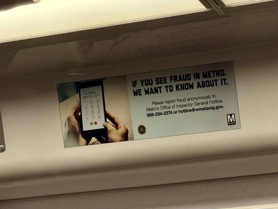 A sign on a Metro train that says “if you see fraud in Metro, we want to hear about it”