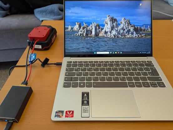 A laptop running off USB power provided by a power supply fed by a 20V electric drill battery