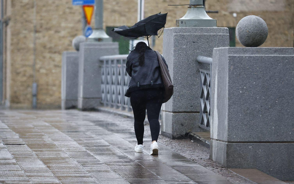 The storm Amy have hit west coast of Scandinavia, a woman in black cloths, brown bag and white sneakers trying to shield herself with an umbrella from the worst of the rain, but Amy has flipped it inside out in rage.
(Image: Thomas Johansson)