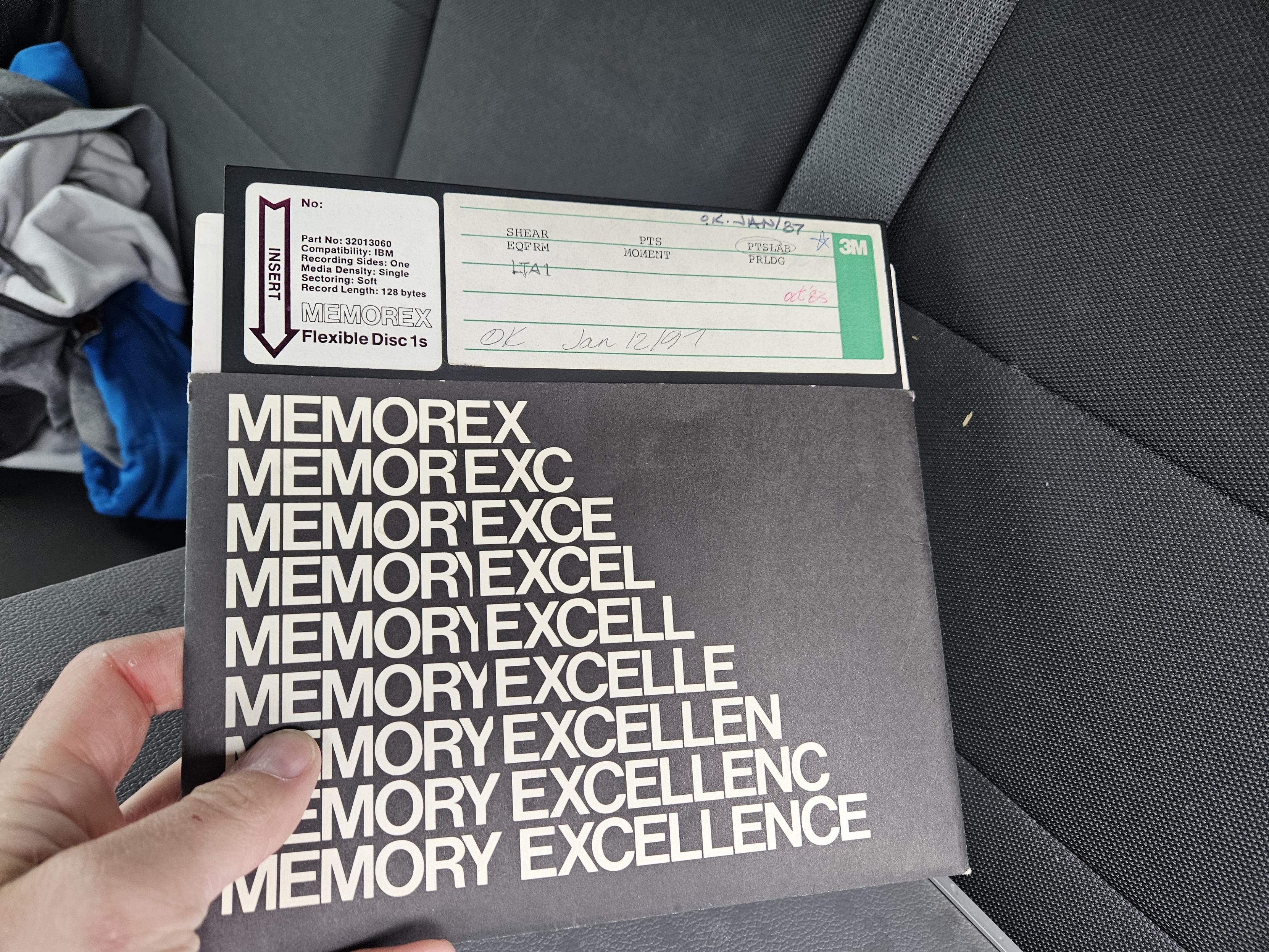 A Memorex branded 8" floppy diskette. The label shows the name "Memorex" changing to "Memory Excellence"