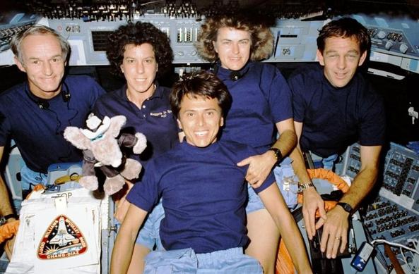 the Atlantis space mission crew and their plushy mascot

Find more on the mission and crew at https://en.wikipedia.org/wiki/STS-34