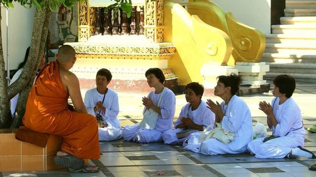 Buddhist monastic teaching lay people.