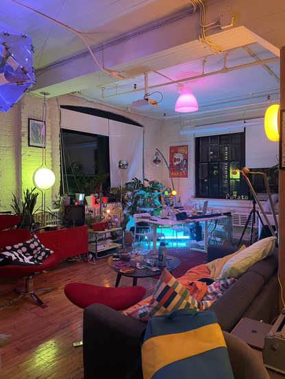 Livestream set up in the corner of a room with ambient lighting all around it