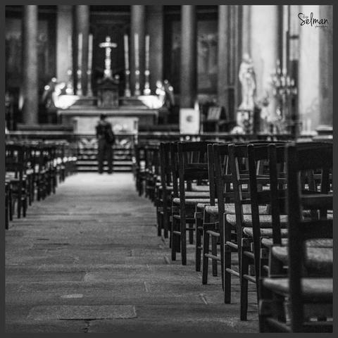 Interior of the cathedral with wooden chairs in the foreground. Rennes, France. Black and white photography. Copyright Silvijo Selman.