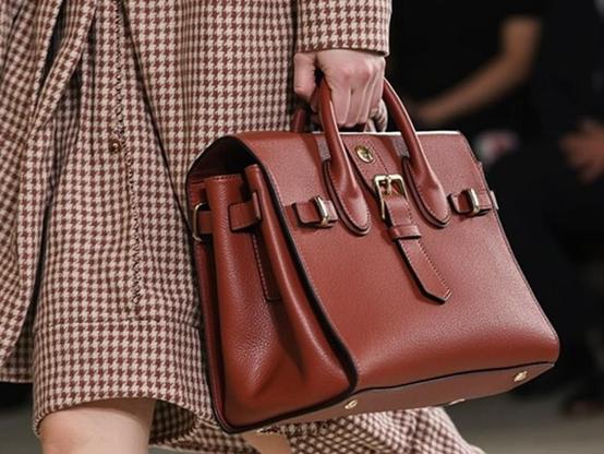 Woman carrying a new Brix + Bailey Leather Grab Bag at Paris Fashion Week