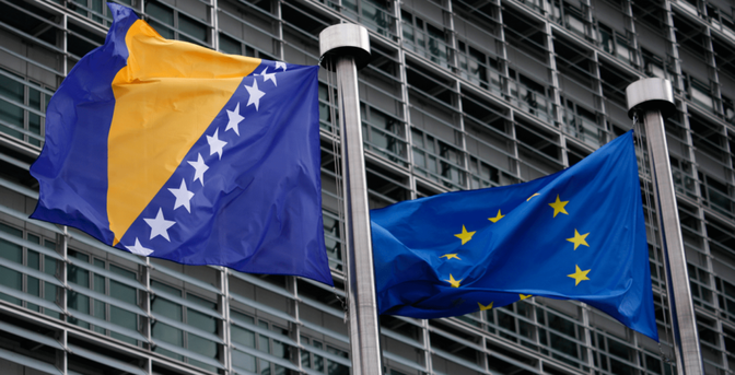 Image of two flags, one of Bosnia and Herzegovina which is a blue rectangle with a yellow triangle in the middle with 9 white stars across the triangles base and the European Union flag which is blue with a circle of stars blowing in the wind 