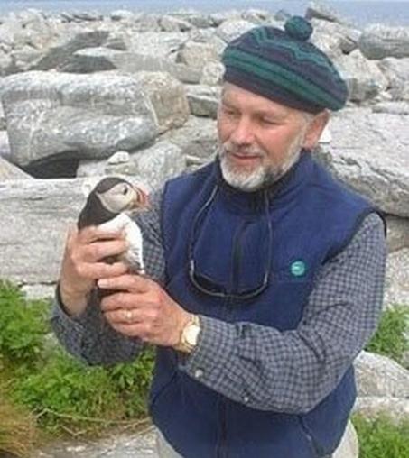 Stephen Kress holding a puffin chick – credit, VOA, public domain