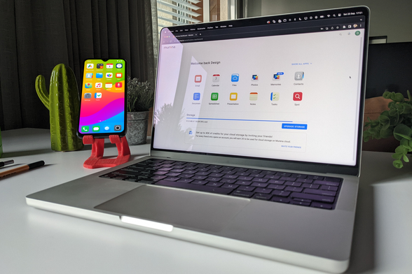 A smartphone and a laptop running on /e/OS with Murena Workspace on a white desk next to a cactus