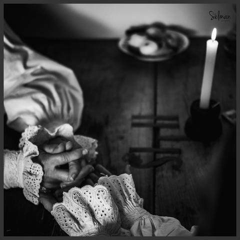 Stories of Strength. The hands of Croatian peasant working women on an old wooden table. Copyright by Silvijo Selman.