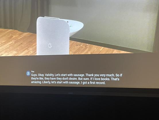 Screen with an empty podium and a bunch of weird English gobbledygook in the captions 