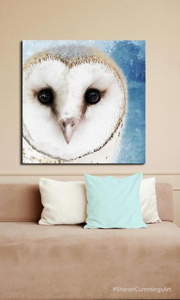 Big barn owl head on blue watercolor by artist Sharon Cummings in a furniture setting.