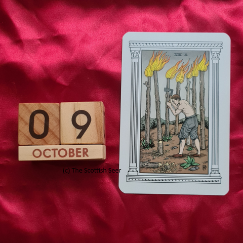 A photo of a wooden block calendar showing the date 09 October next to a tarot card - the 8 of wands.

A man stands in a field holding an axe. There are 7 tall, flaming staffs rising from the soil. The one nearest has cut marks from the axe strike. The staff closest to the viewer has already been felled.