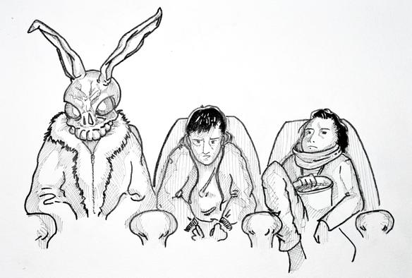 Three characters are depicted on movitheater seats. From left to right, a man in a fur suit waering a creepy rabbit mask, a young man with a concerned face, a young woman looking bored eating popcorn. Scene from the movie Donnie Darko