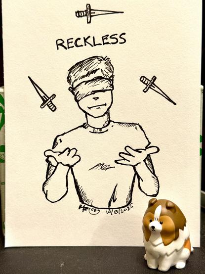 Inktober 2025 day 8: Reckless. An ink drawing of a blindfolded man juggling three knives. An Angry Sheltie figurine props up the paper the drawing is on.