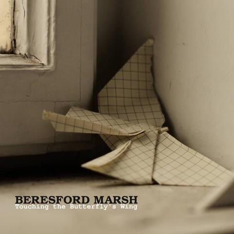 The cover for Beresford Marsh's Ageless somehow album, It shows an origami butterfly made from graph paper rests near a window. Text: "Beresford Marsh Touching the Butterfly's Wing." Earthy tones. 