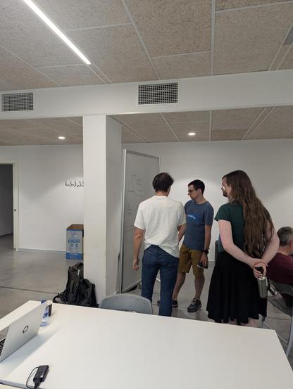 4 Django contributors in front of a whiteboard with a complicated use case