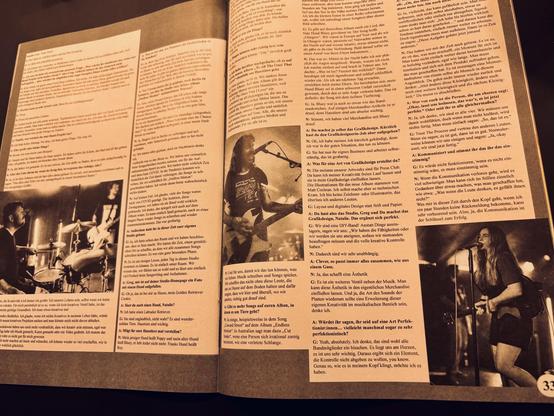 An open magazine page featuring an interview about music and graphic design. On the left, there are black and white photos of a drummer and a guitarist. The right side contains text in German discussing various topics related to music and creativity.