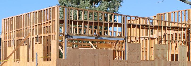 Wood framing for roof sloping to left and parapet sloping to right.
