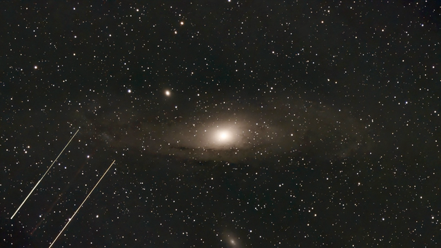 M31 - The Andromeda Galaxy - telescope processed image. There are about 35 satellite galaxies around M31, including M32 and M110, are mostly dwarf galaxies. They exhibit an unusual planar alignment and co-orbiting motion. 