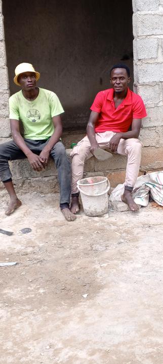Jamie and Me in a red T-shirt... Proudly at the building site in Namayumba town council where all the lessons I mentioned were taken