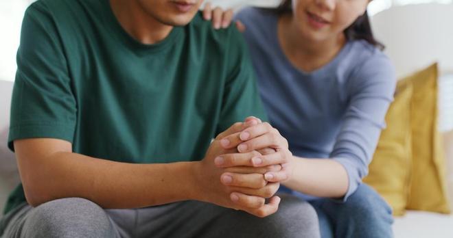 A woman giving a man a hug, supporting his mental health. Image by Chay Tee via Shutterstock.
