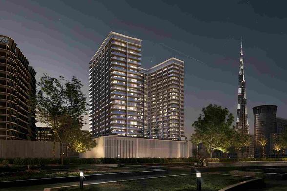 A striking architectural masterpiece, Binghatti Ghost stands tall in the heart of Downtown Dubai, featuring a futuristic white façade with sharp geometric lines and sleek glass balconies. The tower is illuminated dramatically against the evening sky, reflecting the surrounding Burj Khalifa, Dubai Canal, and the glittering skyline. The luxurious residential tower exudes elegance and modernity, with a sense of mystery and grandeur — embodying the name “Ghost” through its luminous, spectral aesthetic. Palm trees, luxury cars, and the vibrant cityscape add to the upscale urban atmosphere.