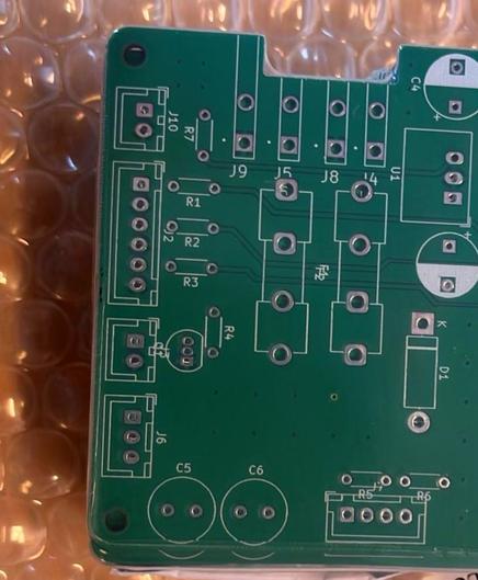 Unpopulated green printed circuit board on bubble wrap