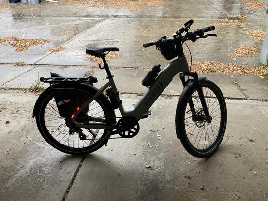 A bike with rain on the pavement in the background.