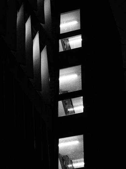 Black and white photograph of the stairwell windows of a local multistorey car park