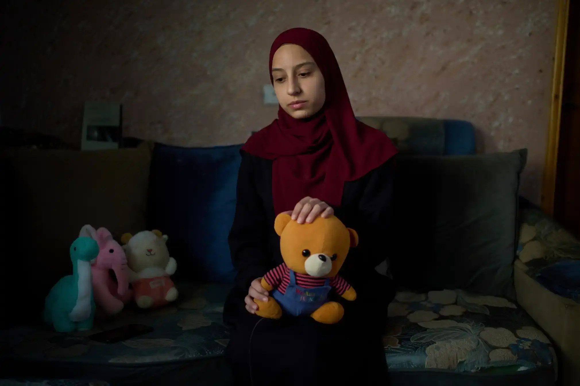 Tayma Asous holds the favourite toy (a small teddy bear) of her two-year-old daughter, Layla Al-Khatib.