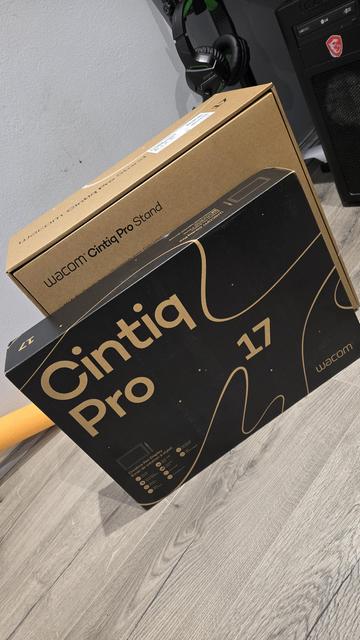 Two boxes - foreground black with "Cintiq Pro 17" written on it; box behind shows words "wacom cintiq pro stand"