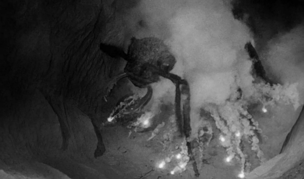 an image of a giant ant, smoke billowing around it, explosions hitting it