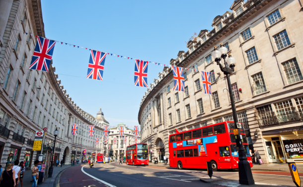 Double decker buses In London with British flags 