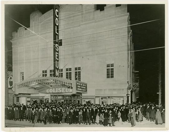A  crowd of people outside of the Coliseum Theater