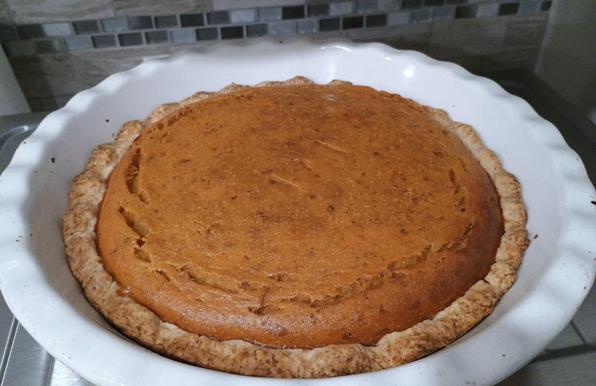 A pumpkin pie is deep golden coloured, in a white pie-baking dish, and it looks at us as if to say, sure I'm tasty with hints of cinnamon, nutmeg and ginger, but don't confuse me with one of your tarted-up latte drinks, I'm the real deal, baby. If you want a pumpkin spice beverage, just haul your sorry ass out to your local chain store, cuz we're only doing the authentic thing in the house today, dude. 

And we're all like, okay, yeah, we respect that.