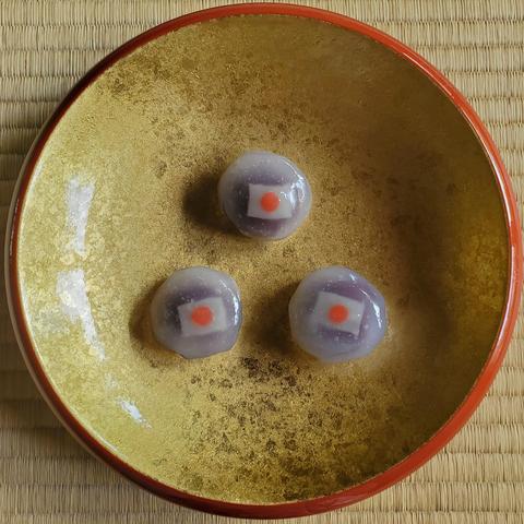 A Japanese flag inspired sweet (the flag sits on a red bean paste with a thin layer of jelly covering the round confection).